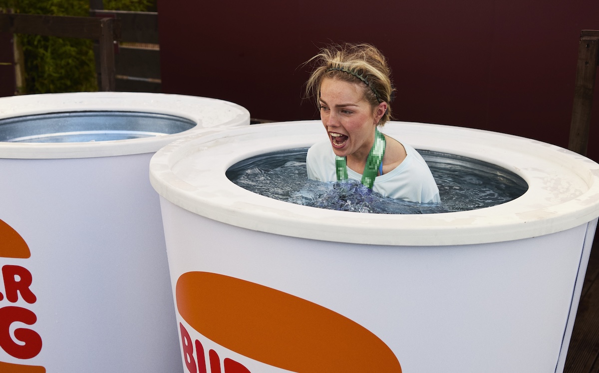 Runner taking part in Burger King's cup-shaped cold plunge activation at the Dublin Marathon